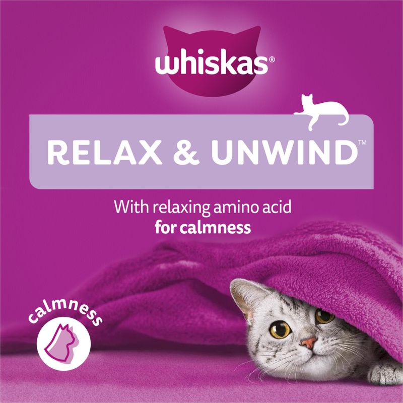 Whiskas cat food package with a cat under a purple blanket on a purple background