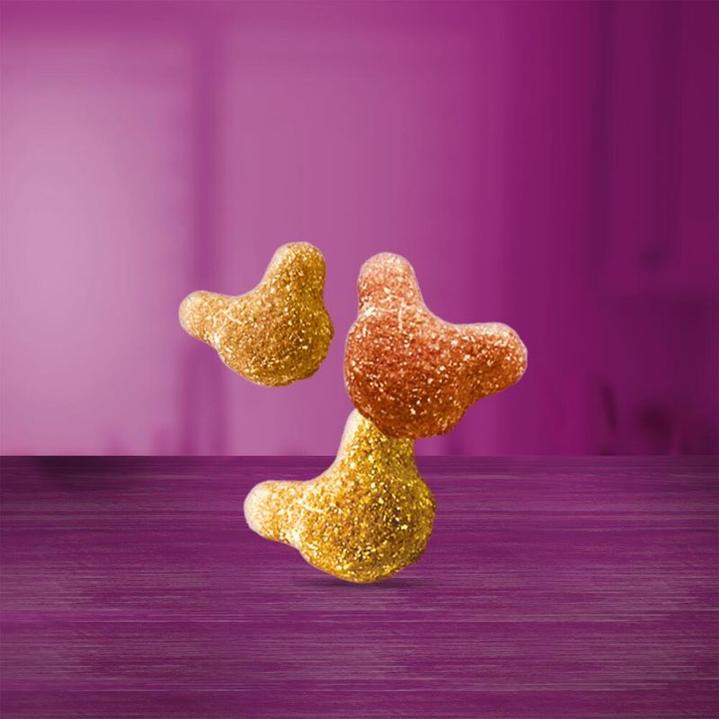 Two glittery bird figurines on a purple surface with a matching purple background