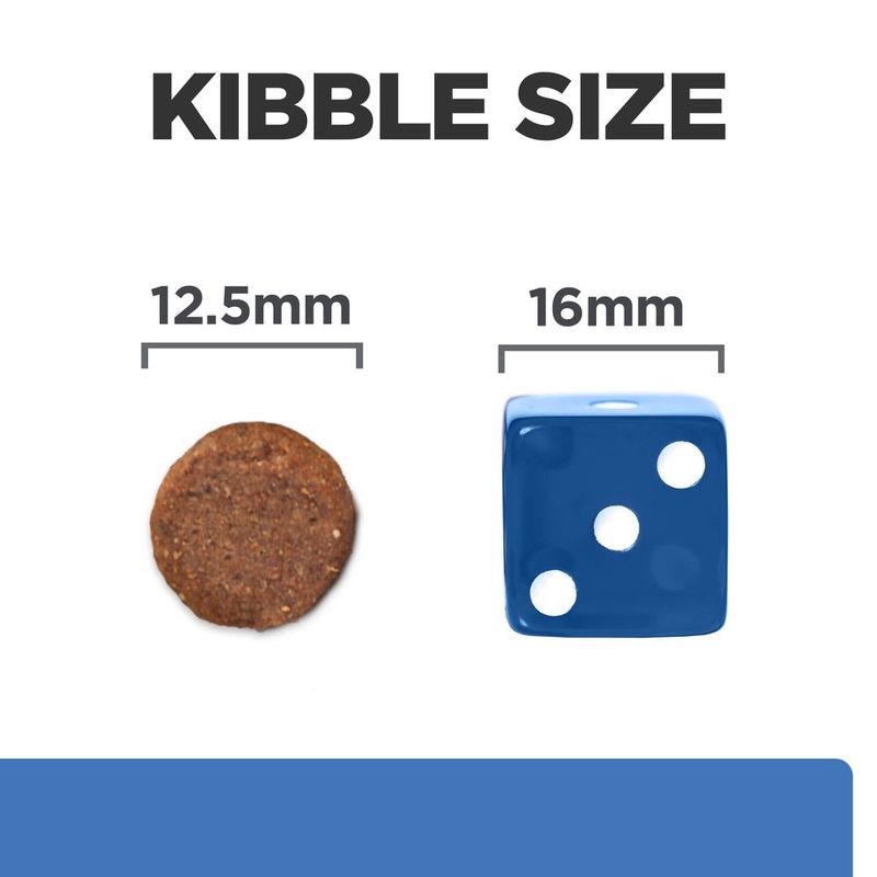 Comparison of kibble size with a round brown kibble and a blue dice showing measurements.