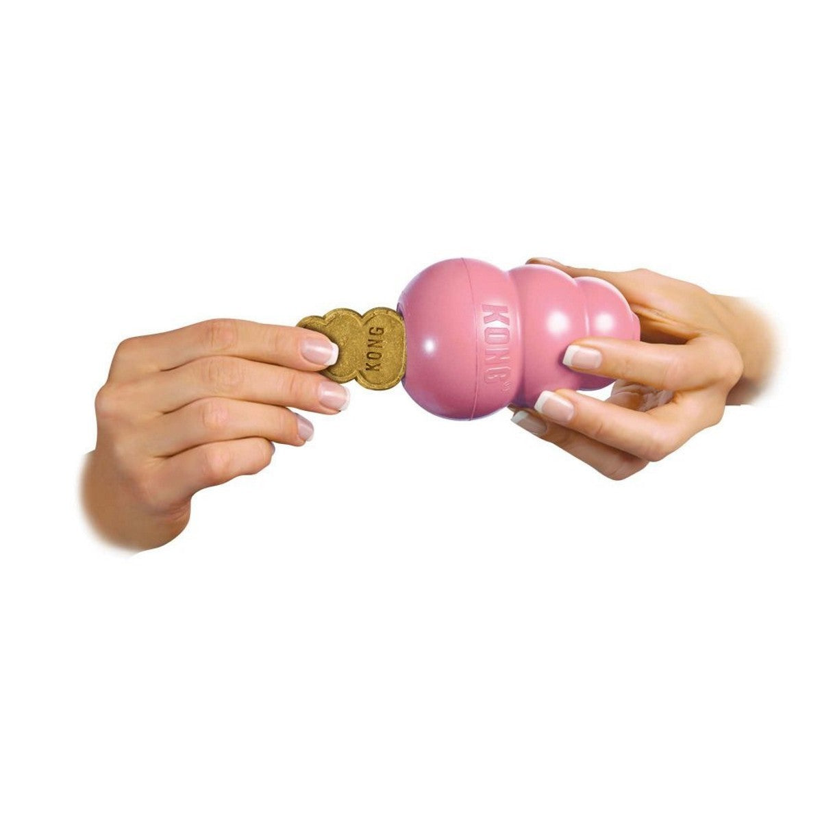 Pink KONG dog toy with a treat on a white background