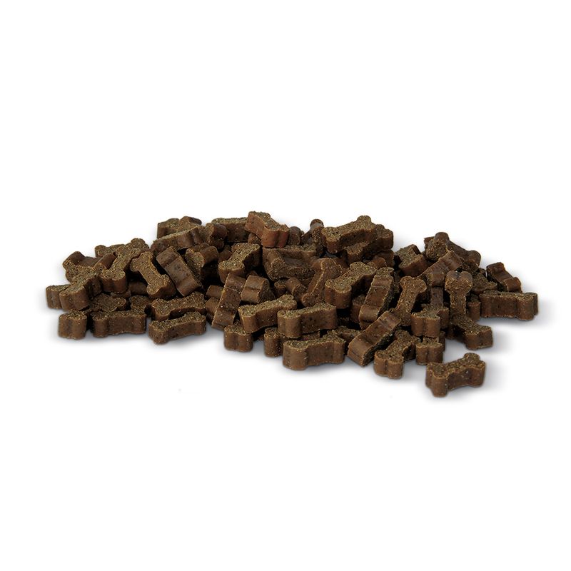 Pile of brown dog treats on a white background