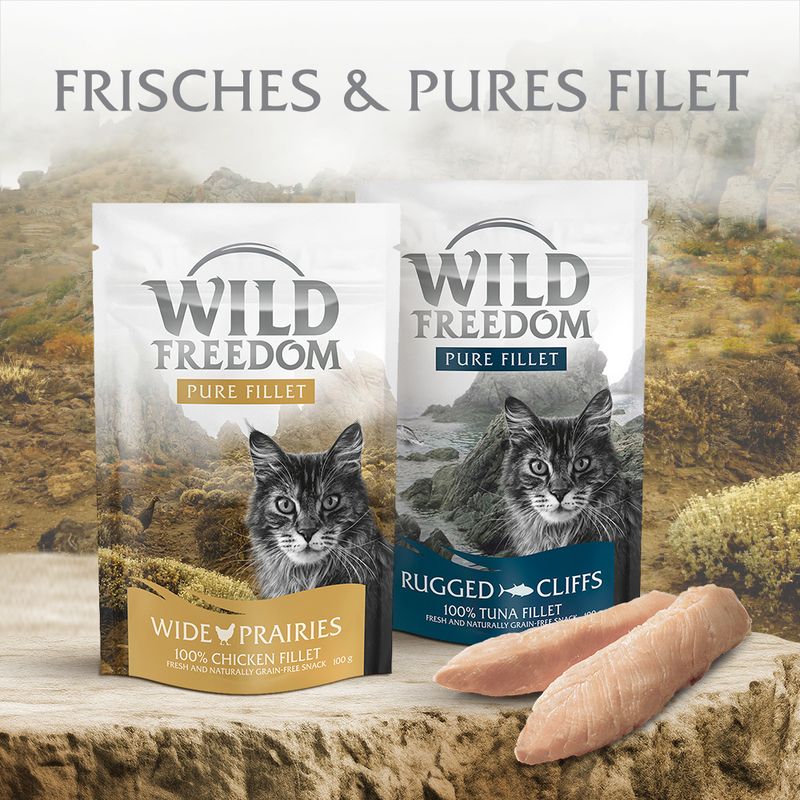 Two packages of Wild Freedom cat food with scenic background