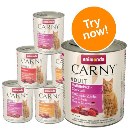 A selection of animonda Carny cat food cans in a mixed pack featuring beef flavors. The packaging prominently displays the brand logo and a cat with the text 'Try now!'.