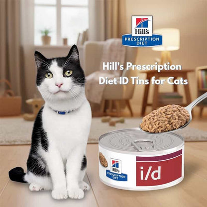 Cat sitting next to a can of Hill's Prescription Diet i/d food with a spoonful of food above it.