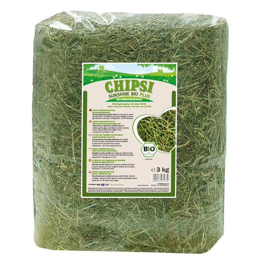 Bag of green hay with a visible label on a white background
