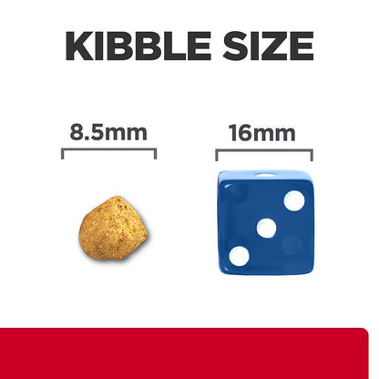 Comparison of kibble size to a blue die with measurements on a white background