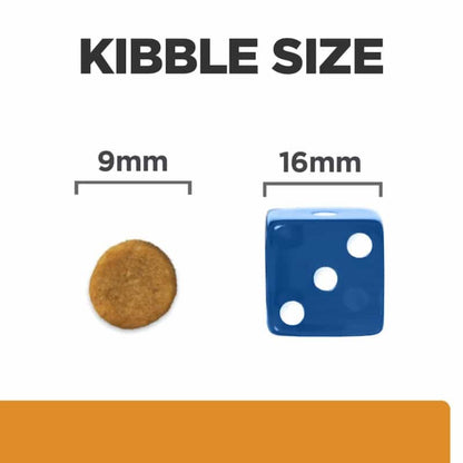 Comparison of kibble size to a blue die with measurements on a white background